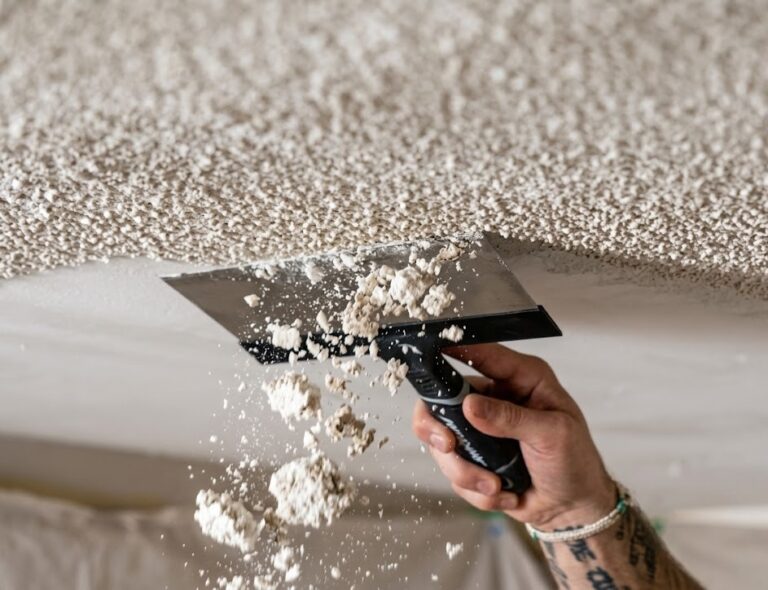 Popcorn ceiling asbestos: close-up of textured popcorn ceiling being scraped with a putty knife