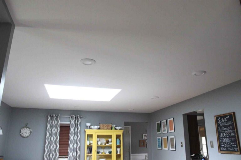 Smooth, freshly painted ceiling after popcorn texture removal