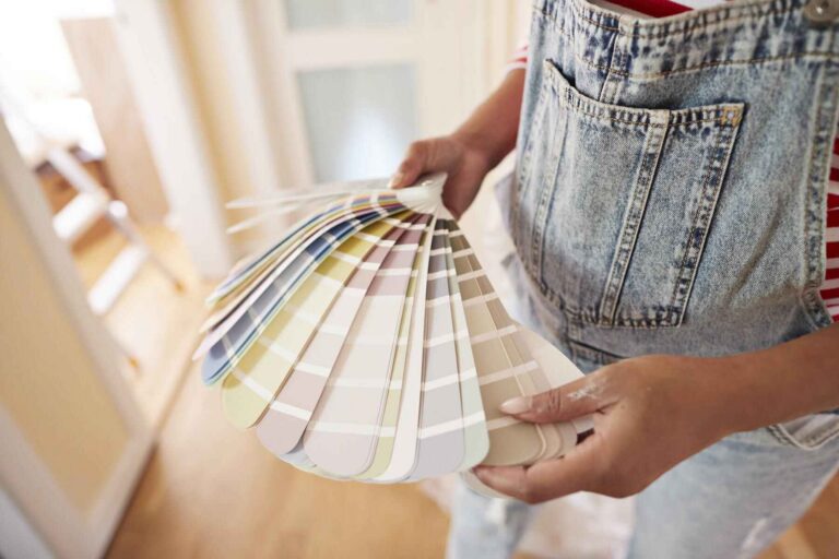 Homeowner holding a paint color fan deck