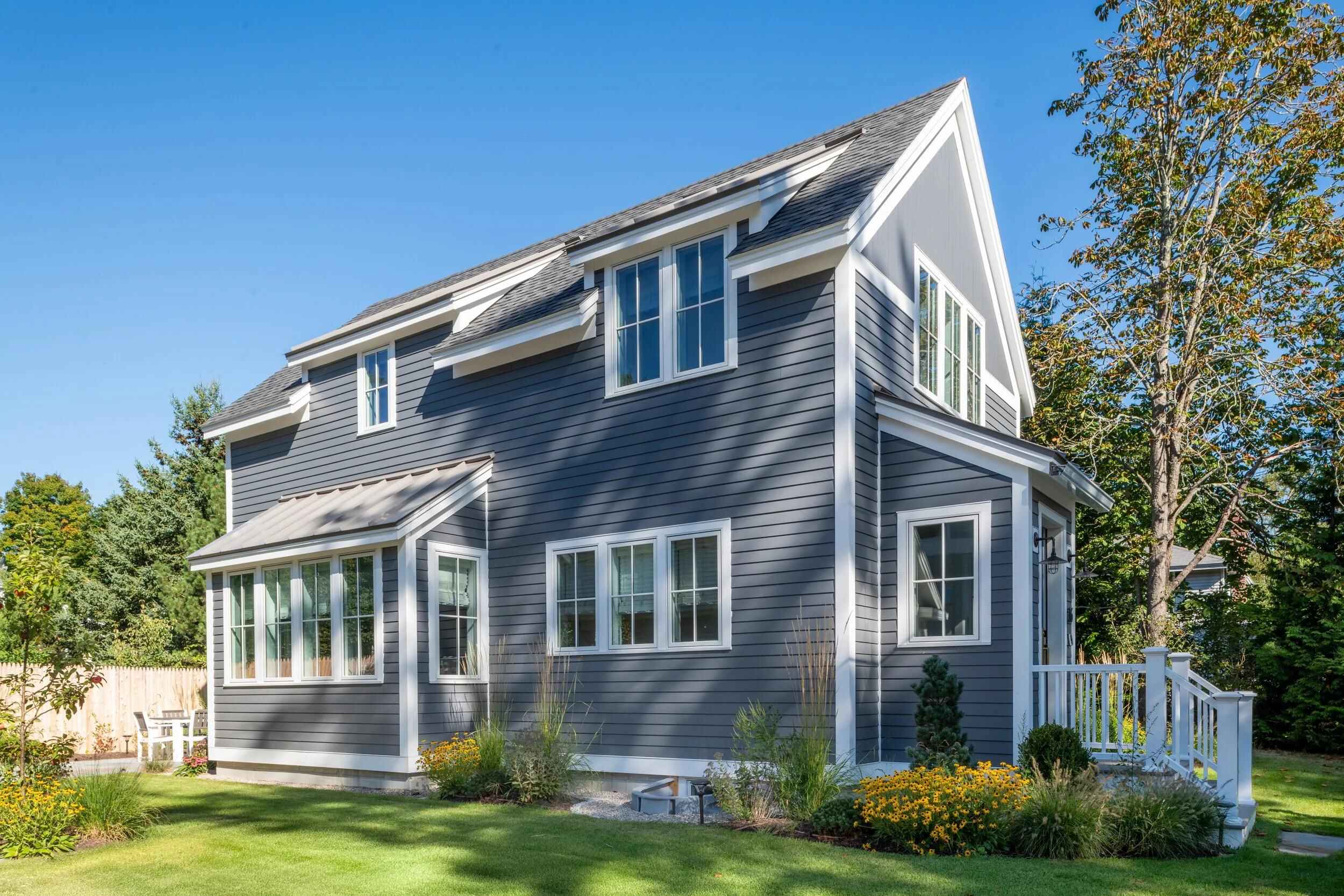 House painters Burlington MA homeowners hire, blue-gray two-story home with fresh white trim