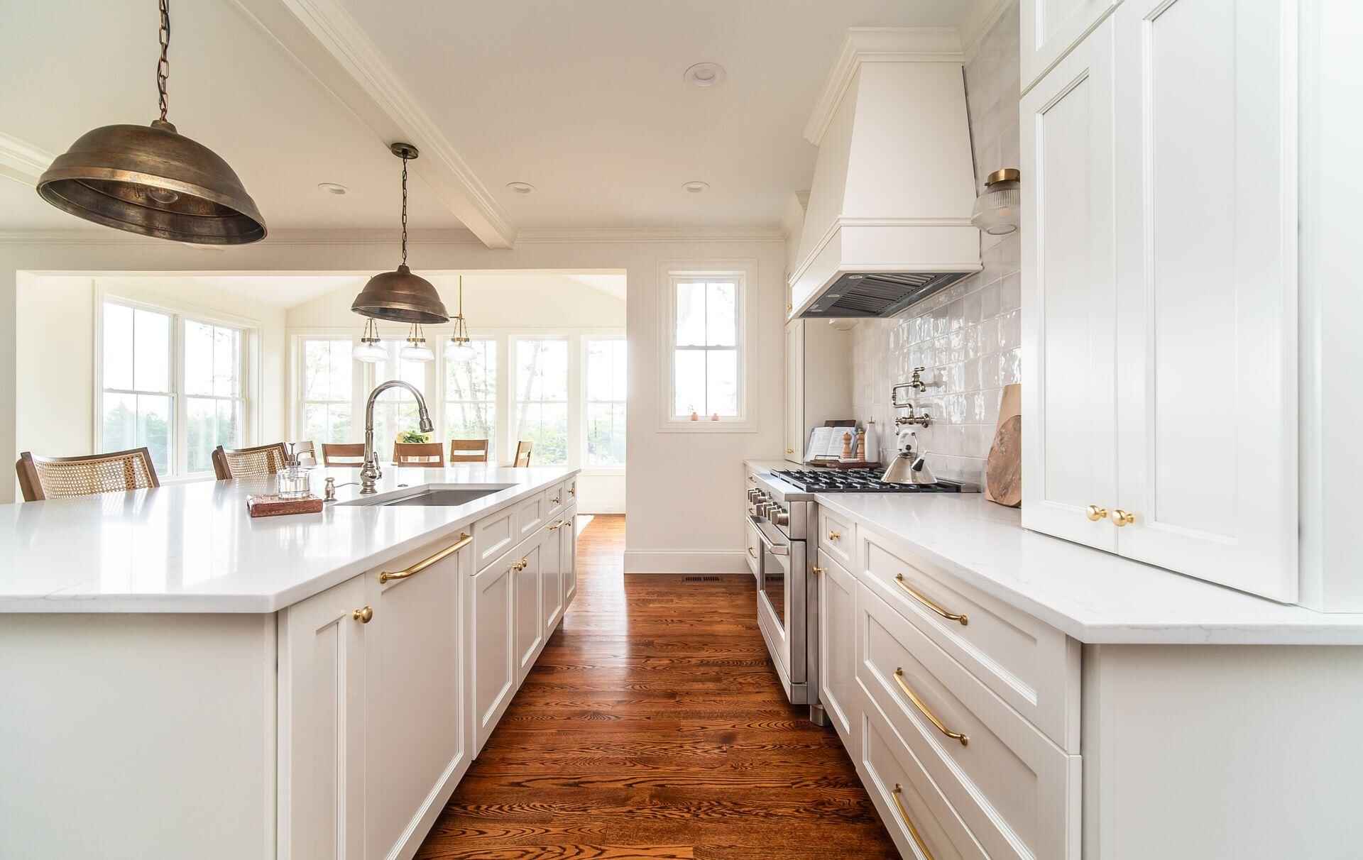 White kitchen walls with warm wood floors after interior painting